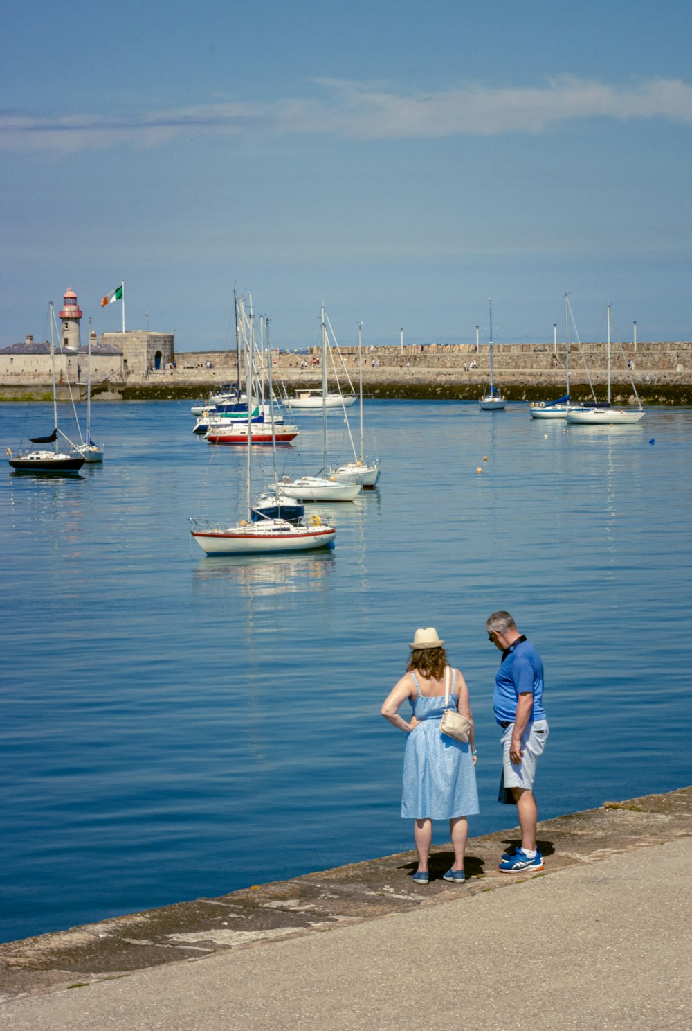 2 boys standing on white boat on sea during daytime