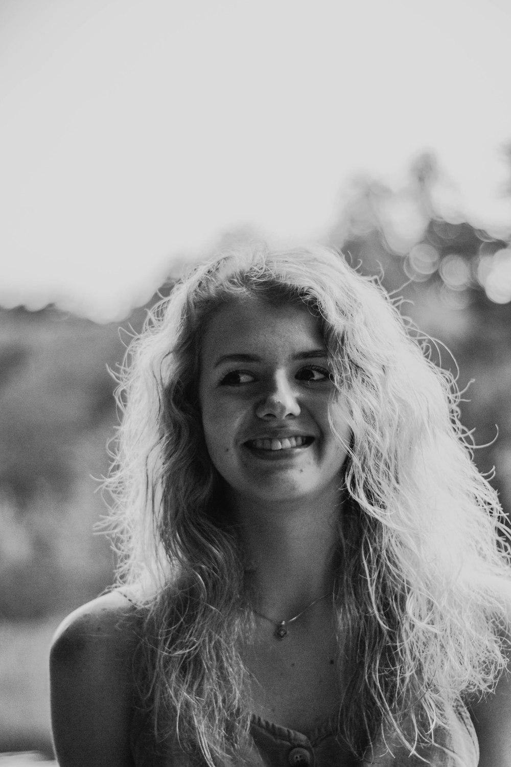 grayscale photo of woman smiling