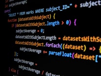 Lines of computer code are displayed on a dark background, featuring SQL and JavaScript syntax with colorful syntax highlighting. The code includes a SQL query and JavaScript function handling datasets.