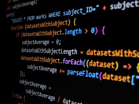 Lines of computer code are displayed on a dark background, featuring SQL and JavaScript syntax with colorful syntax highlighting. The code includes a SQL query and JavaScript function handling datasets.