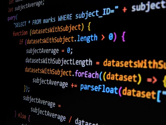 Lines of computer code are displayed on a dark background, featuring SQL and JavaScript syntax with colorful syntax highlighting. The code includes a SQL query and JavaScript function handling datasets.