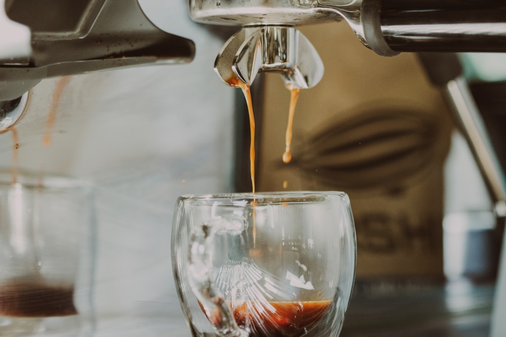 clear glass cup with brown liquid