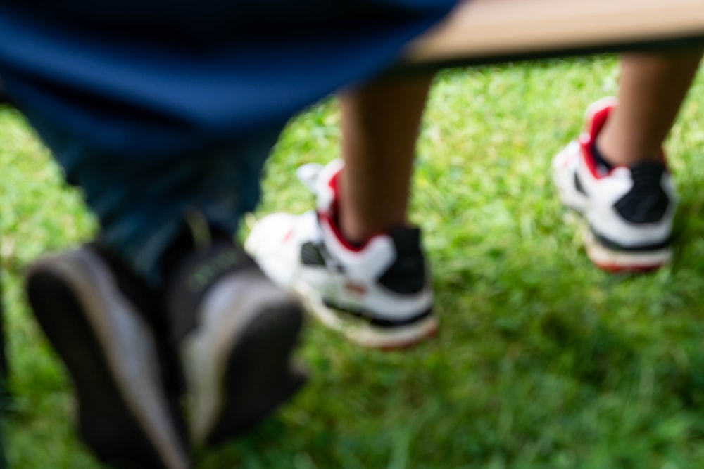 person in blue shorts and white and red nike sneakers