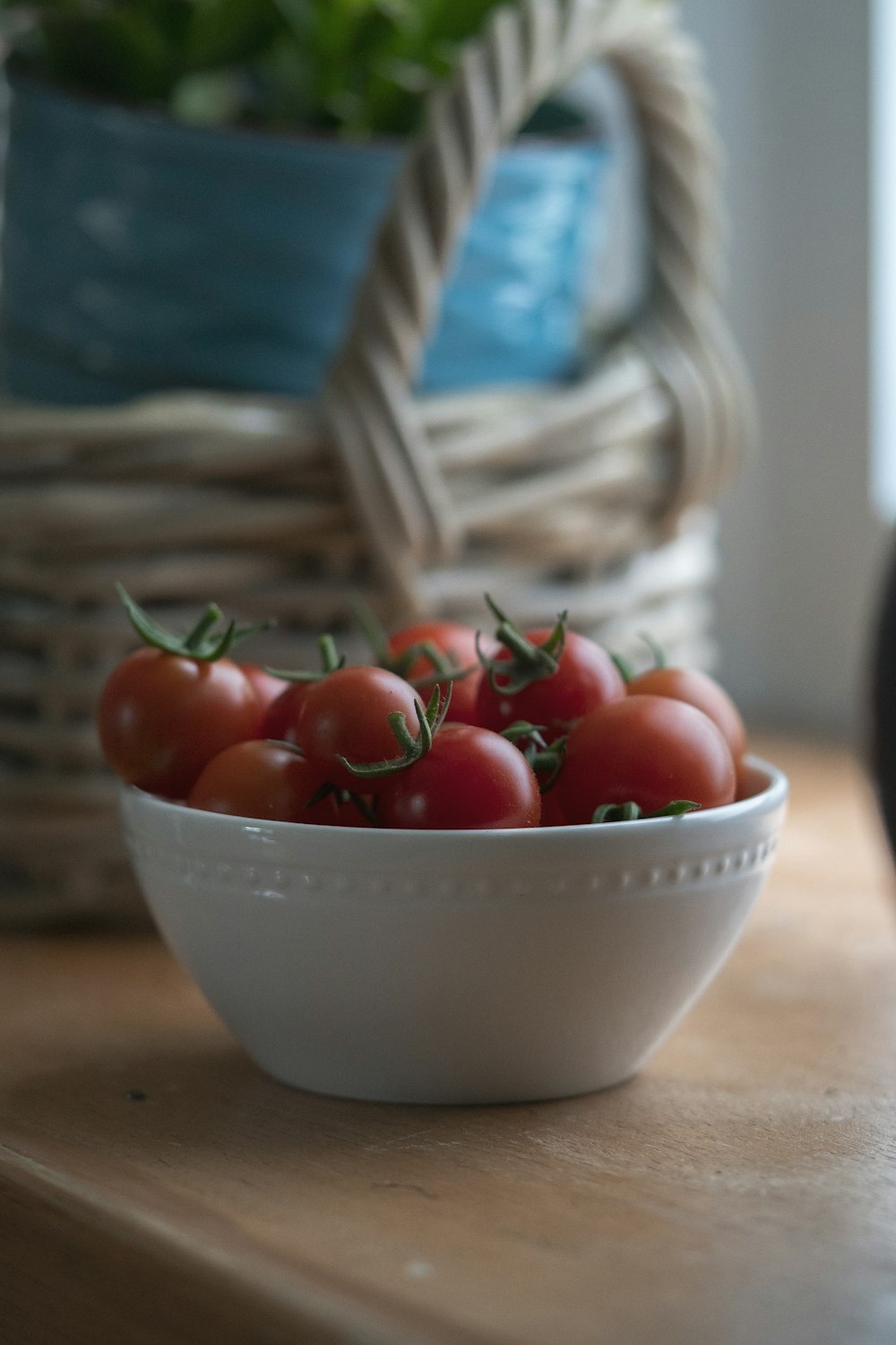red cherry tomatoes in white ceramic bowl