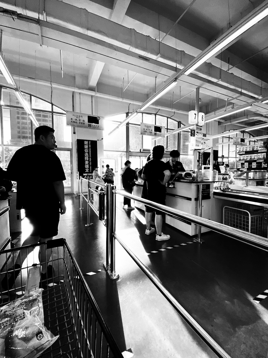 grayscale photo of people in a building