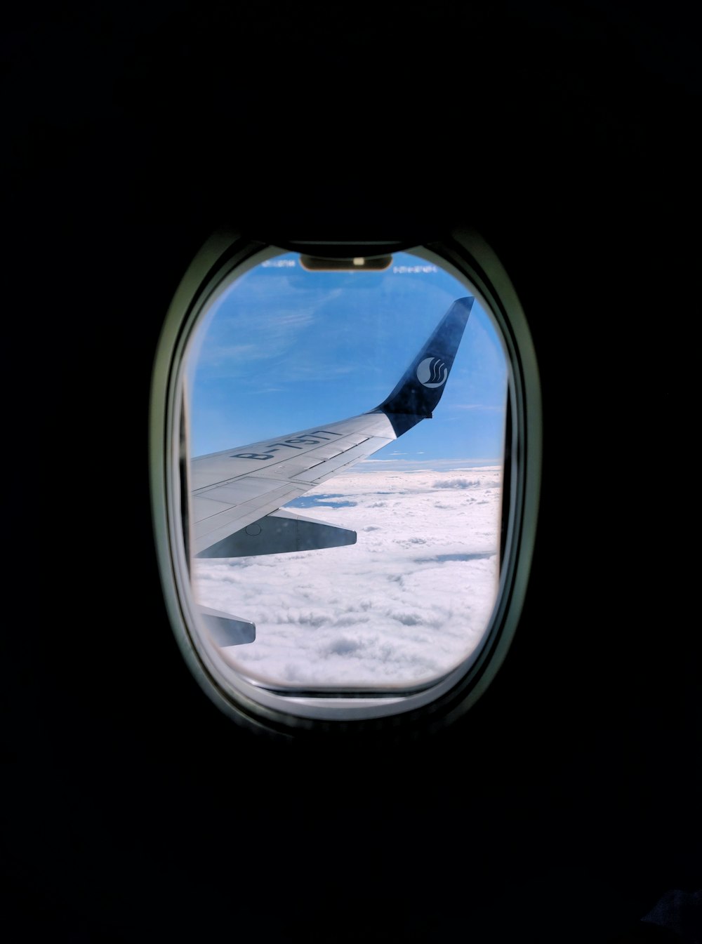 airplane window view of white clouds during daytime