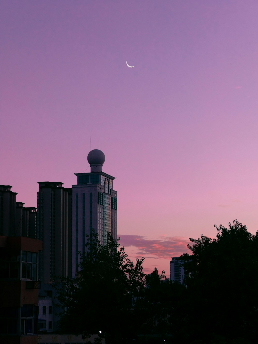 high rise building under purple sky