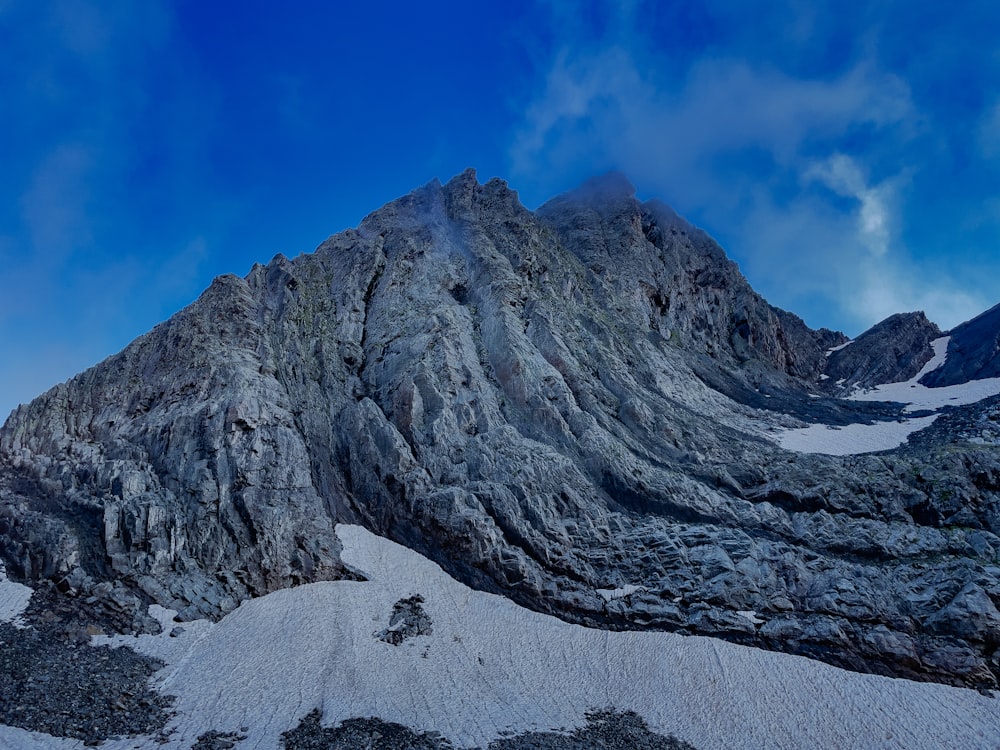 gray rocky mountain under blue sky during daytime