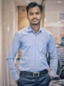 man in blue and white dress shirt and black pants