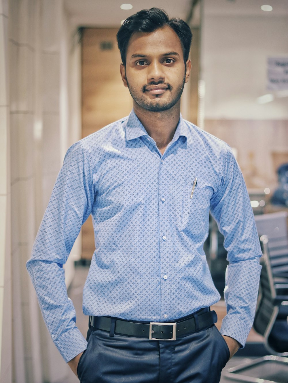 man in blue and white dress shirt and black pants