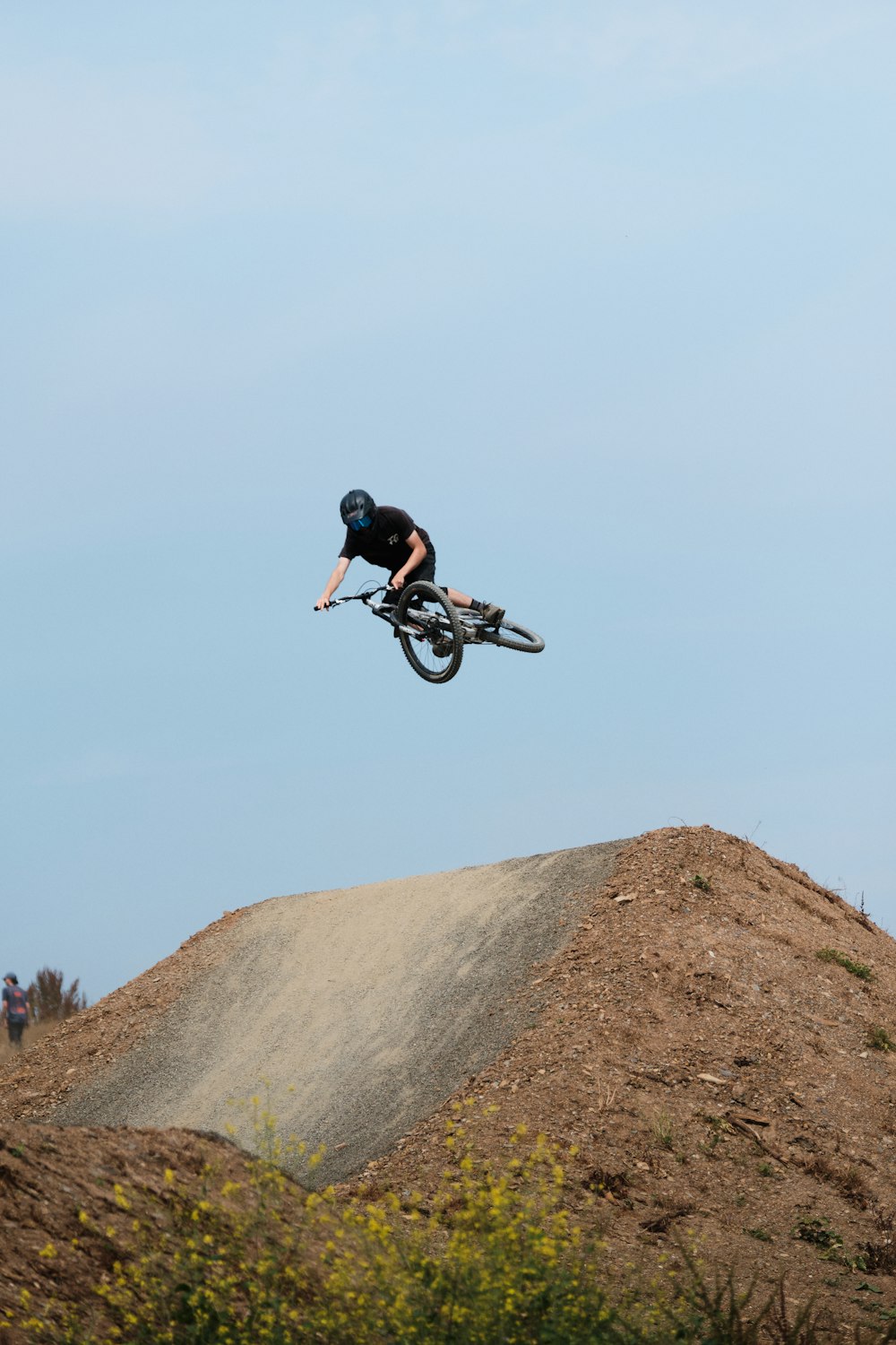 man in black jacket riding on black mountain bike during daytime