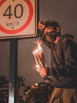 man in black jacket holding fire