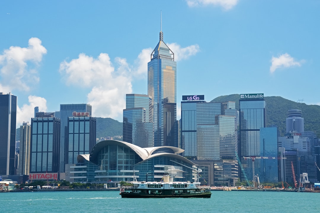 white and blue high rise buildings near body of water during daytime