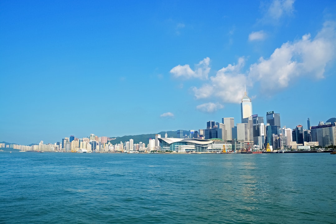 city skyline across body of water during daytime