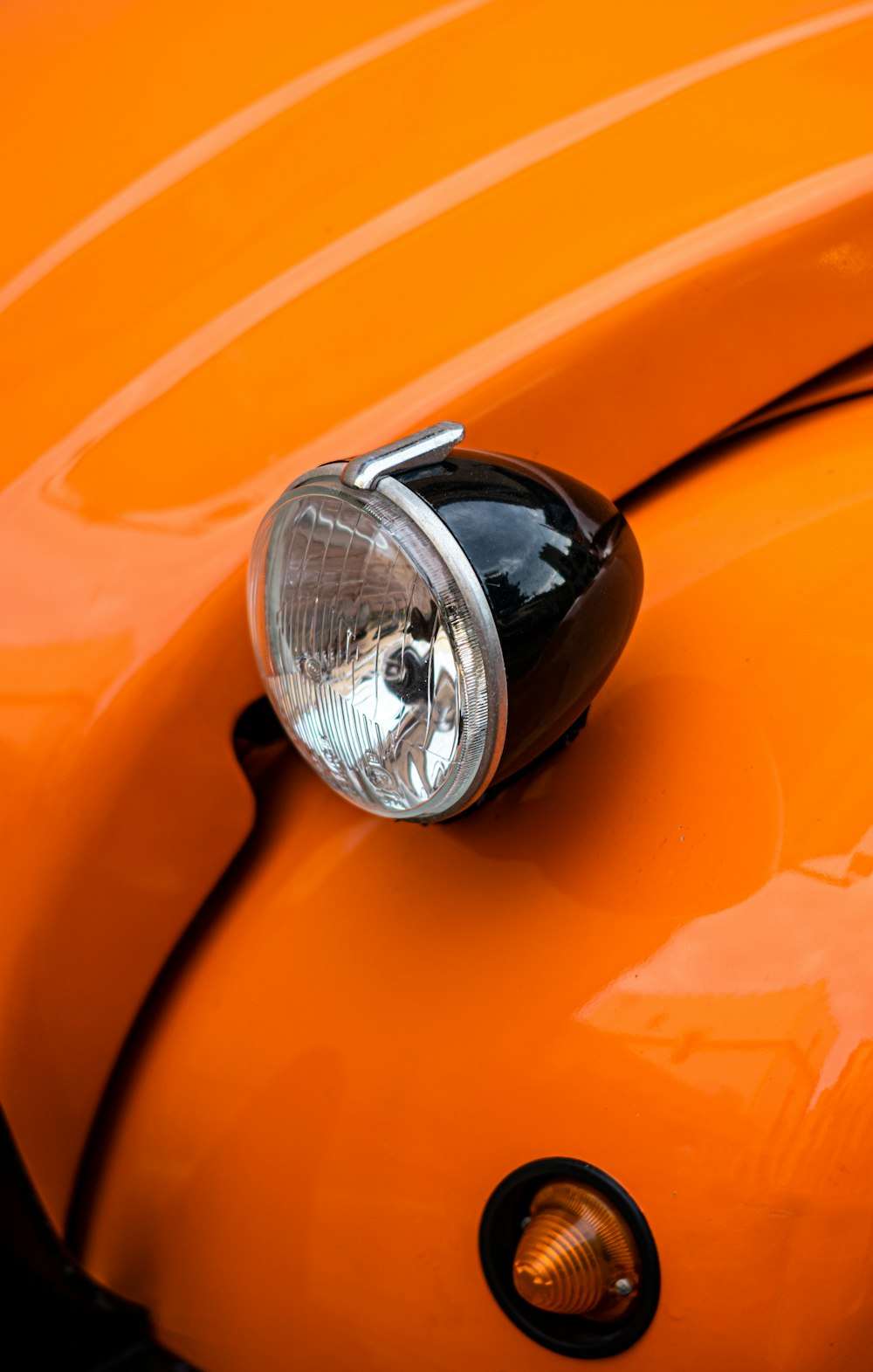 orange car with silver headlight