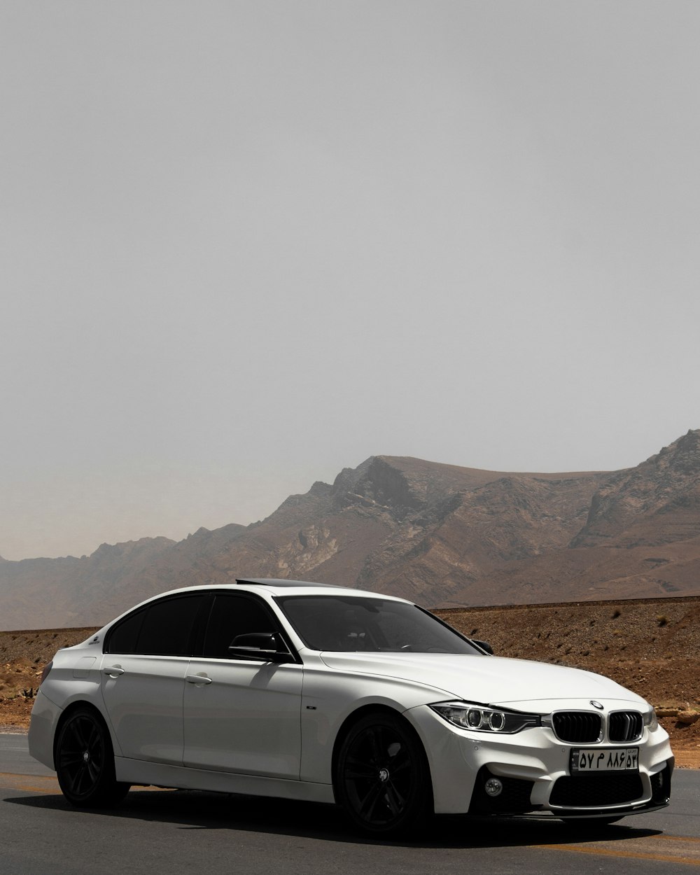 white bmw x series on brown field during daytime