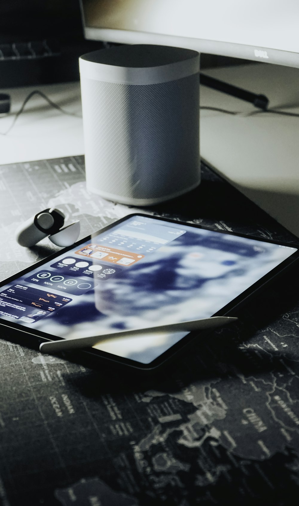 black tablet computer beside white paper towel