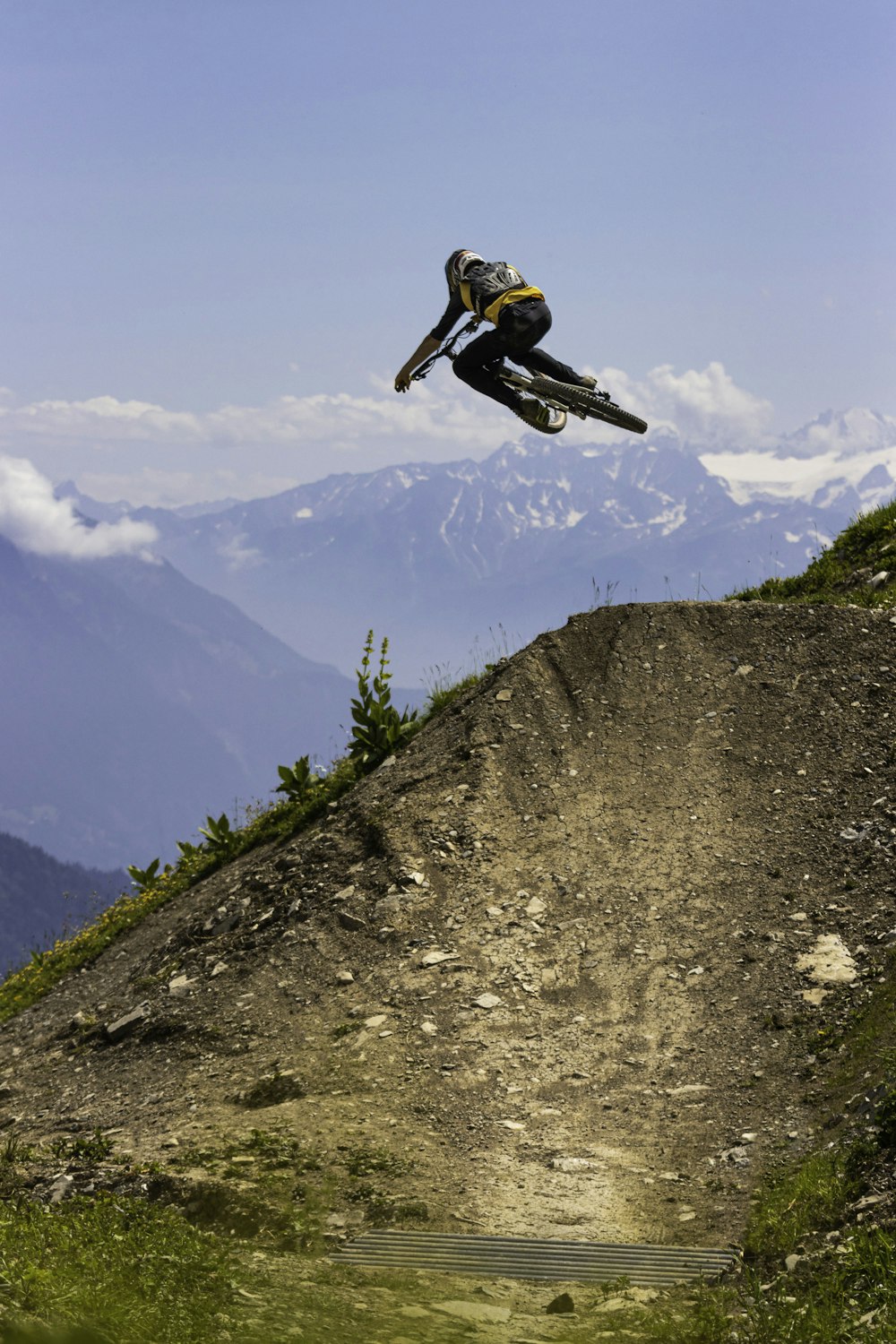 man in black jacket and black helmet riding on motocross dirt bike on mountain during daytime
