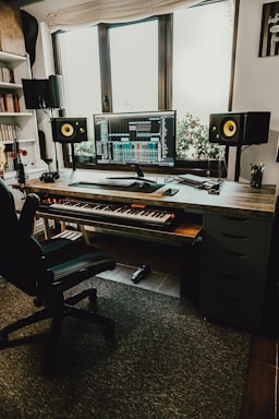 black flat screen computer monitor on brown wooden desk