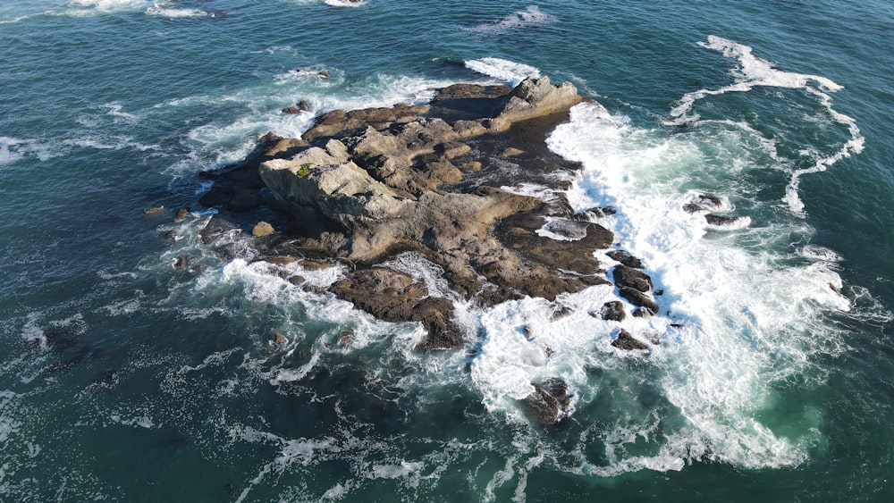 brown rock formation on sea during daytime