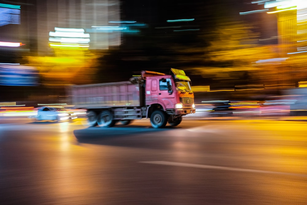 red and yellow truck on road during night time