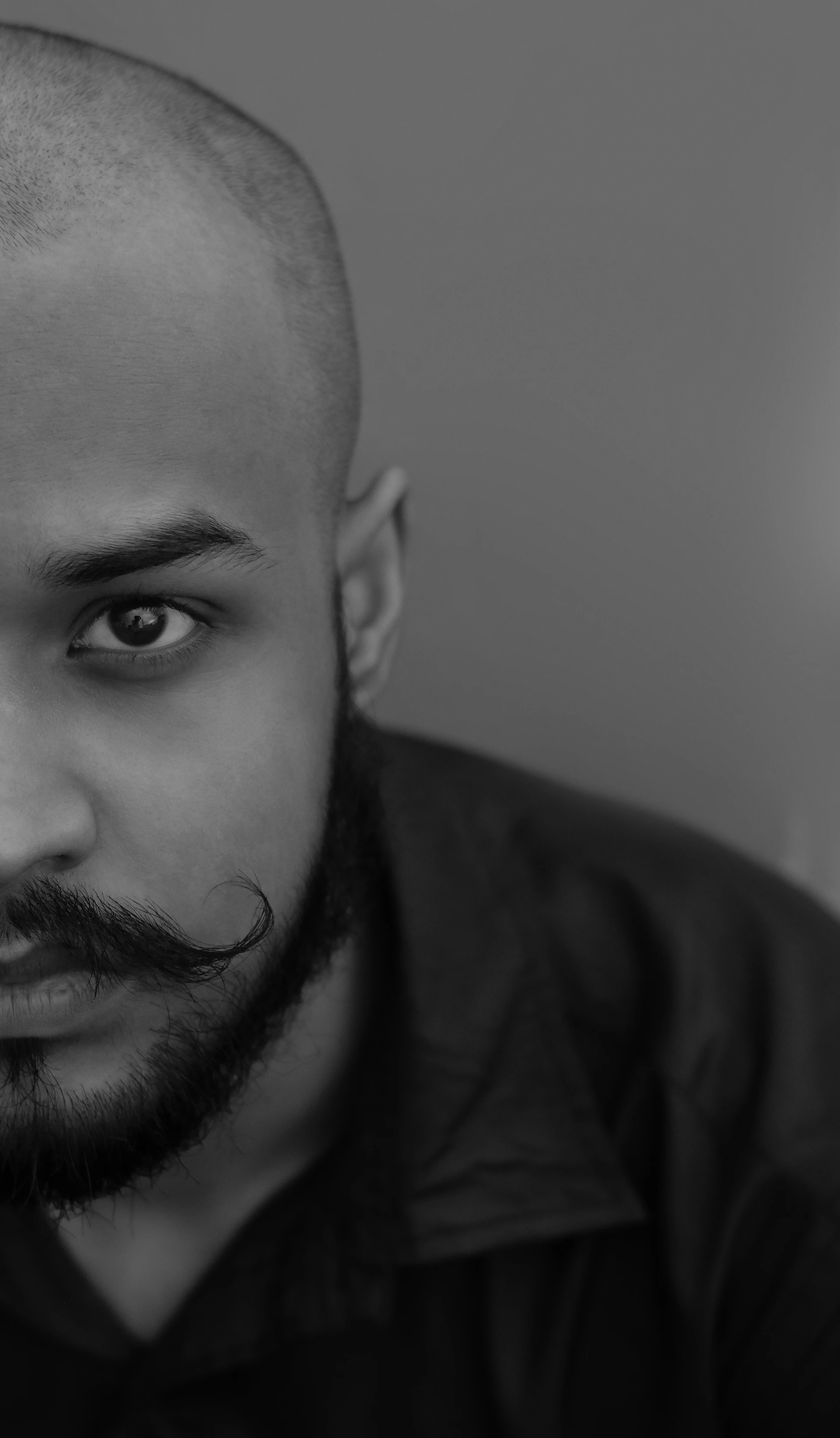 A close-up portrait of Jerry T. Adams in character, showcasing intense focus and determination.