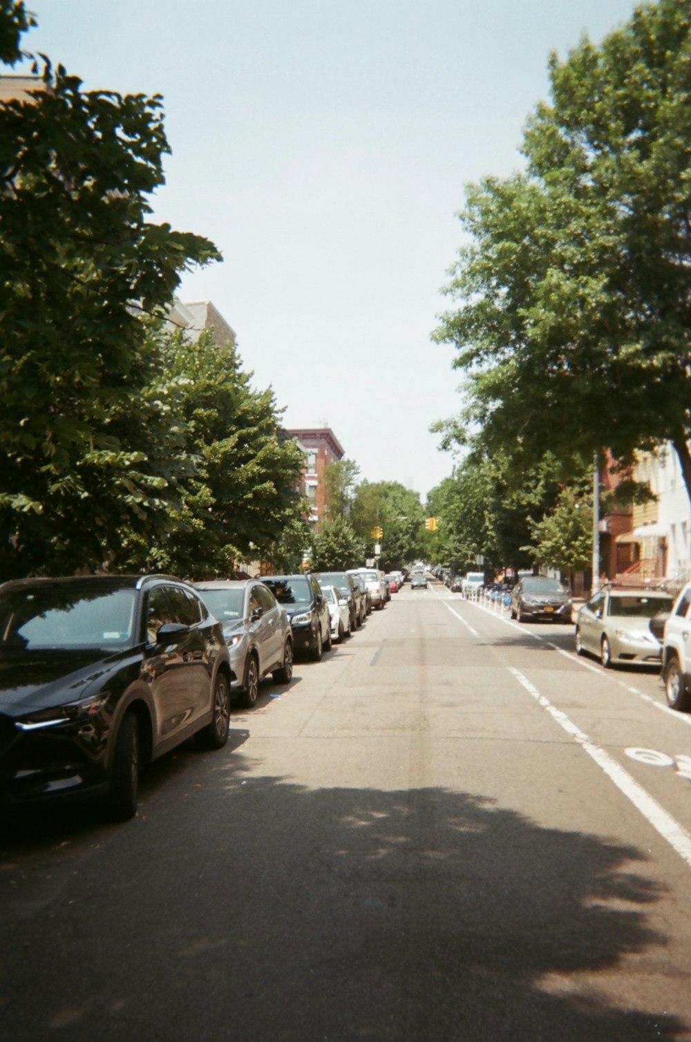 cars parked on sidewalk during daytime