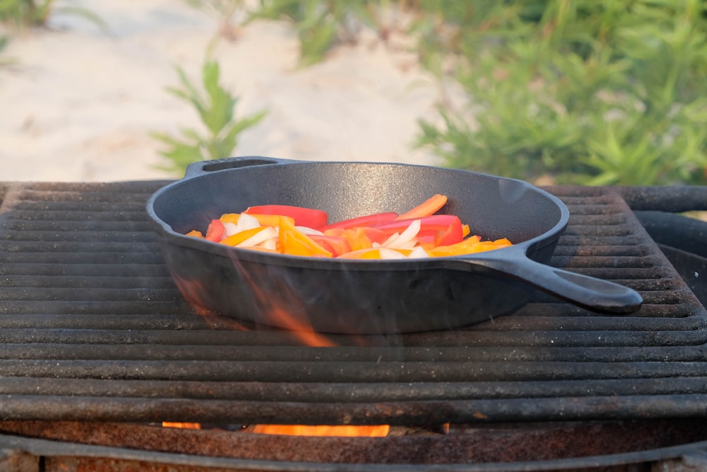 black and orange frying pan on black wooden table