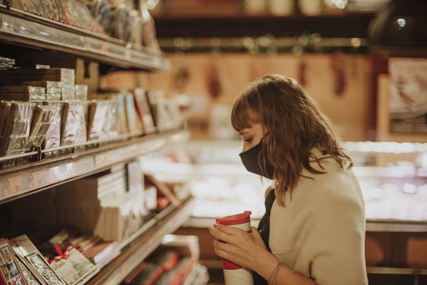 Parent shopping for family essentials in store aisle