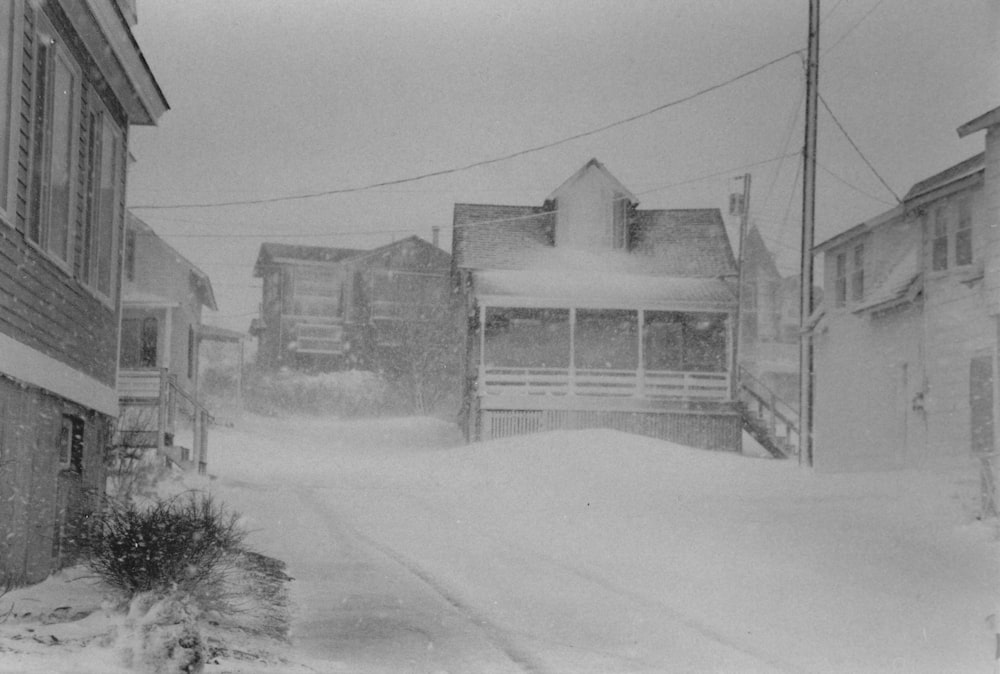 grayscale photo of snow covered road