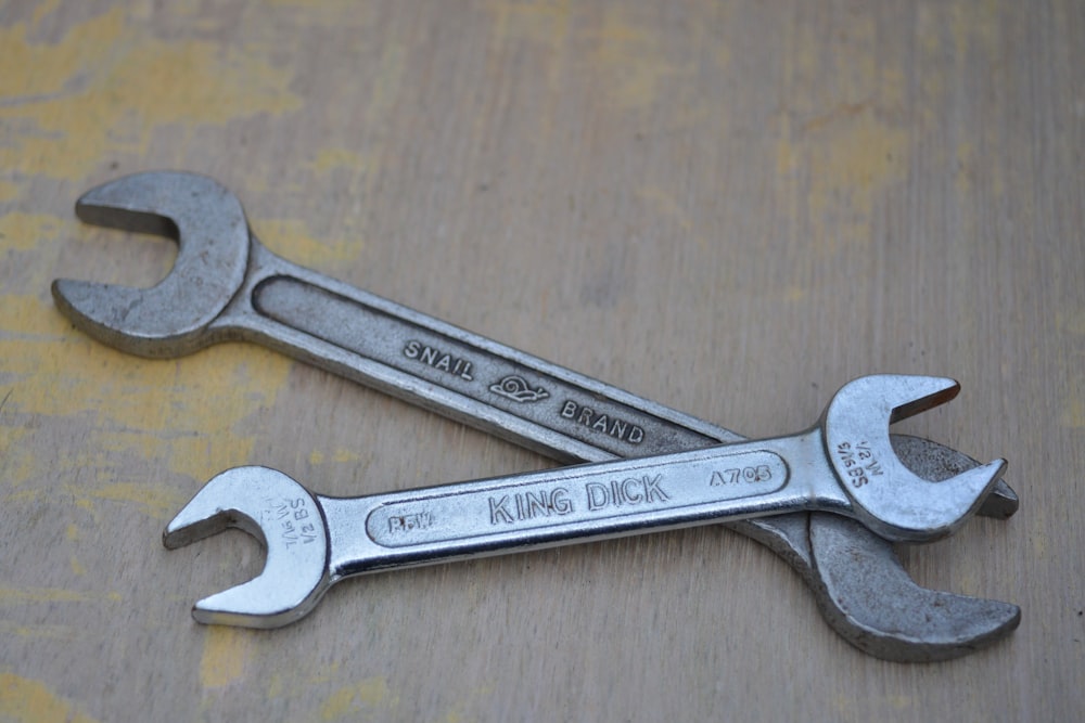 silver steel measuring spoons on brown wooden table