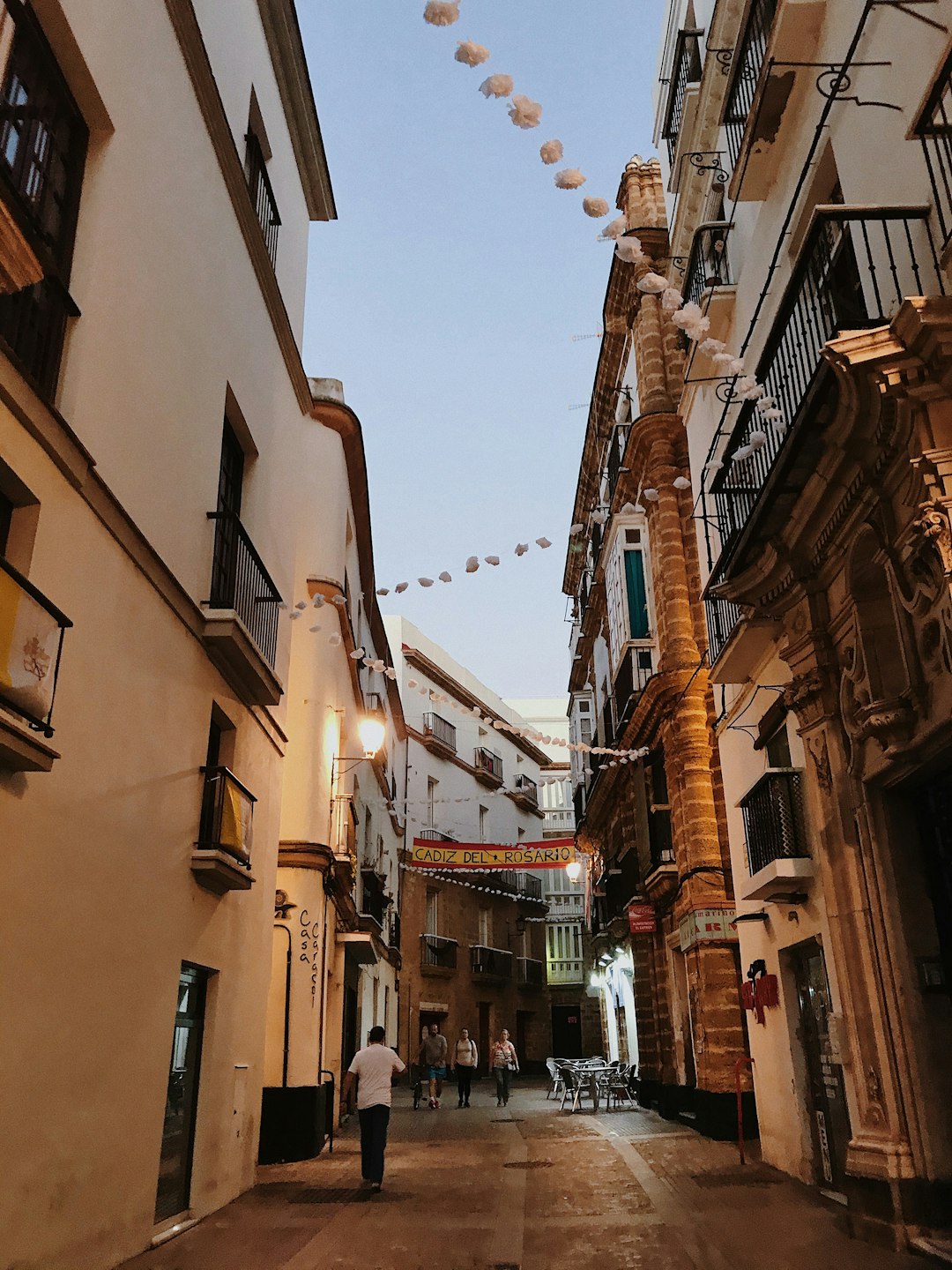 people walking on street between buildings during daytime