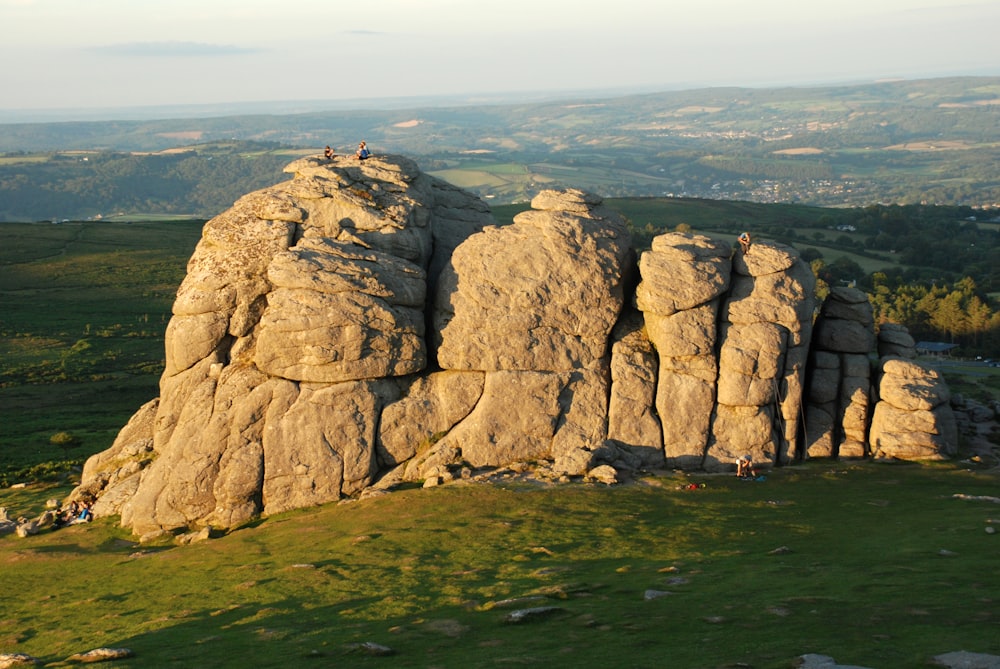 a group of people standing on top of a rock formation