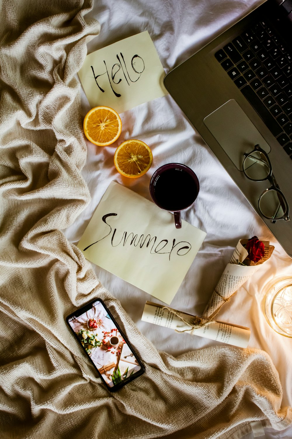 black liquid in clear drinking glass beside silver macbook