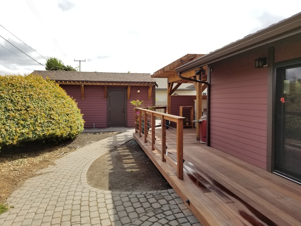 brown wooden house near green trees during daytime