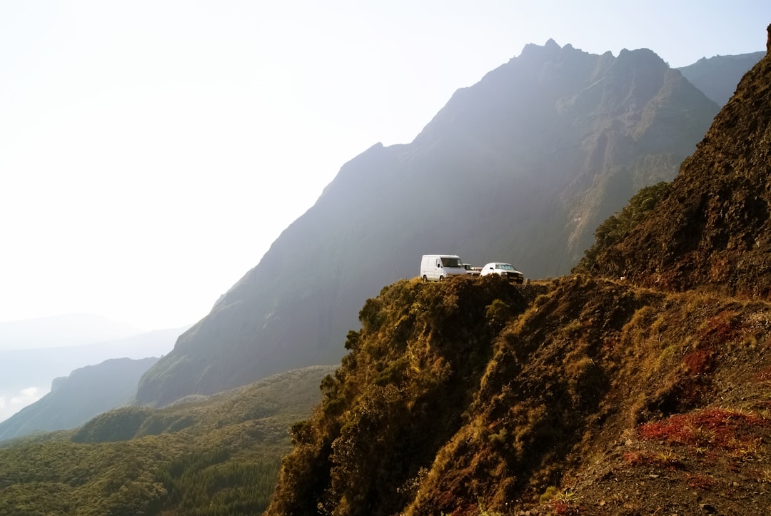 white van on the road near the cliff