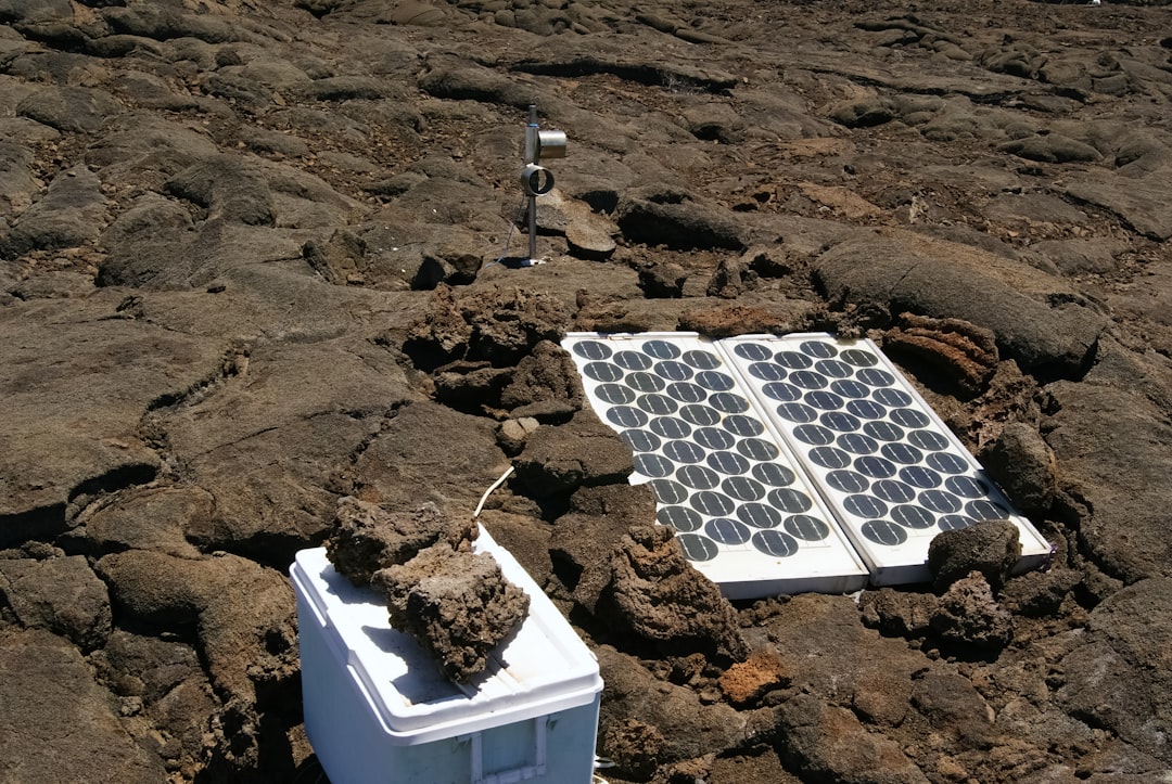 white and black solar panels on brown sand