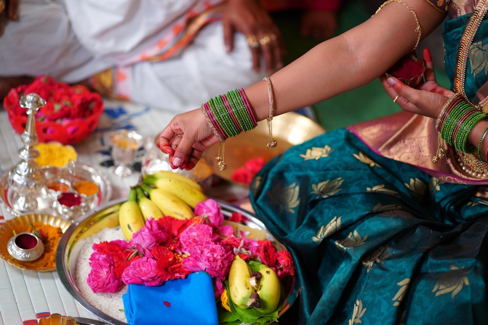 person holding white ceramic plate with fruits