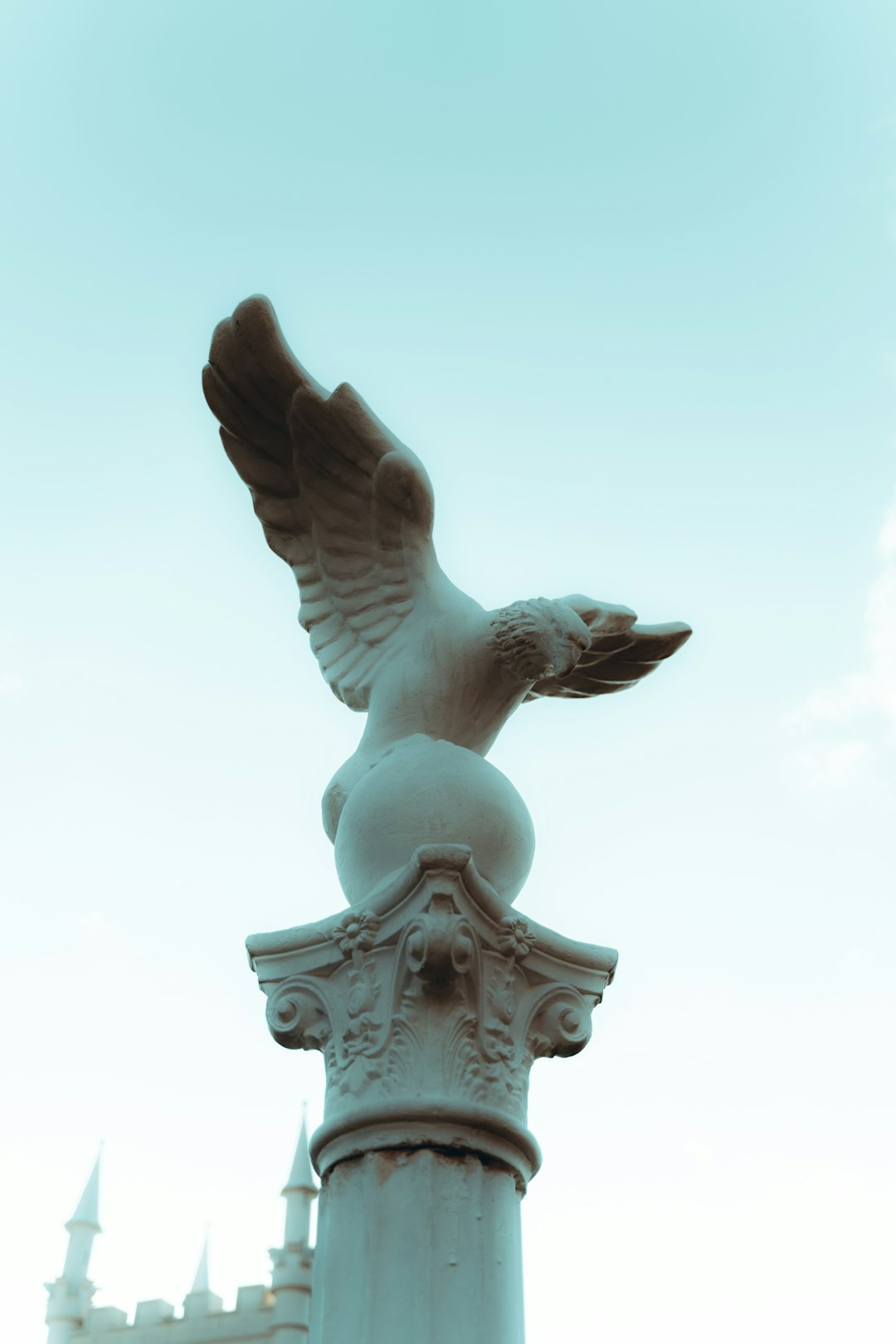 gray bird statue during daytime