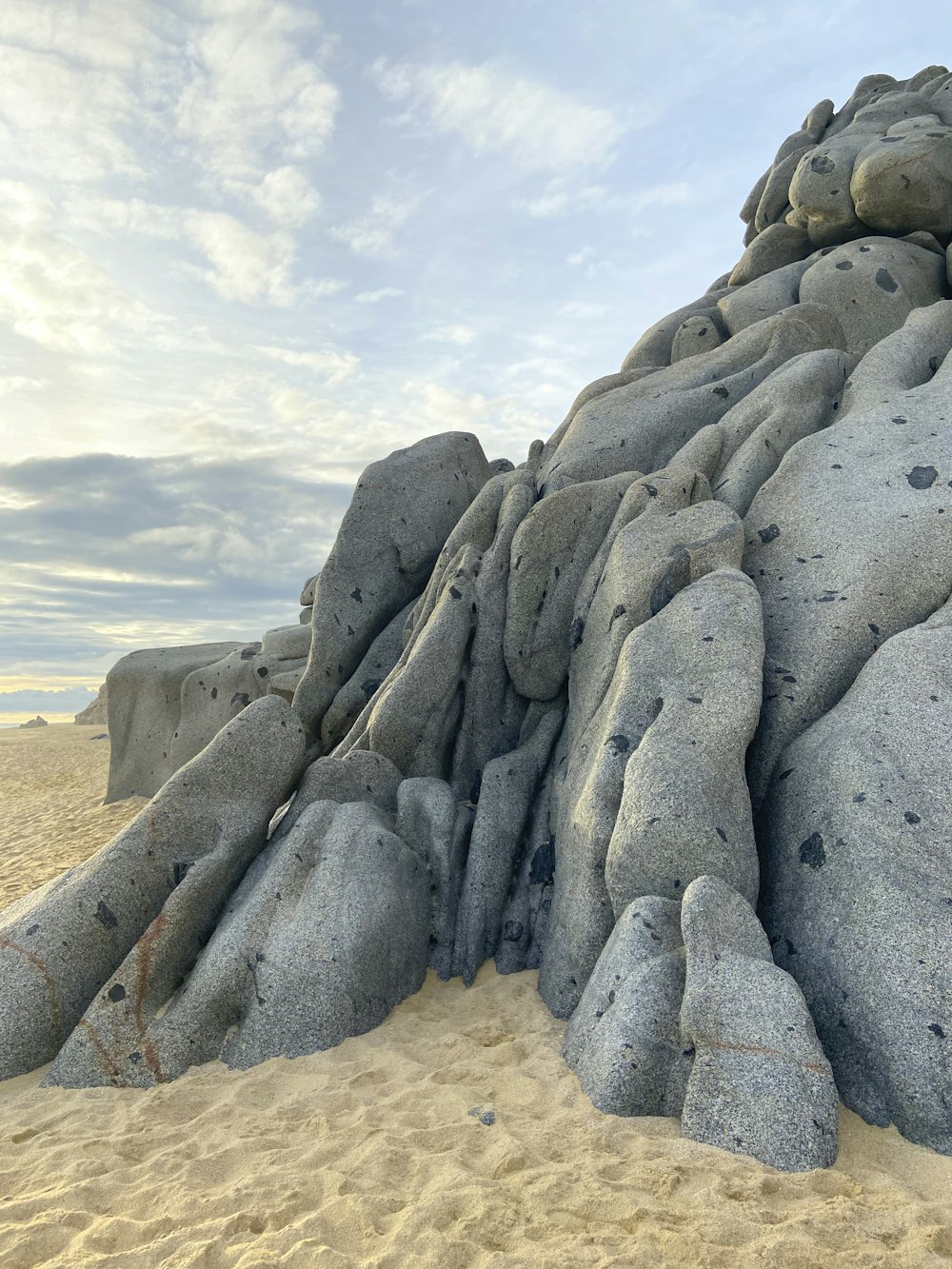 gray rock formation on brown sand during daytime