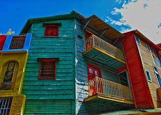 red and white wooden house under blue sky