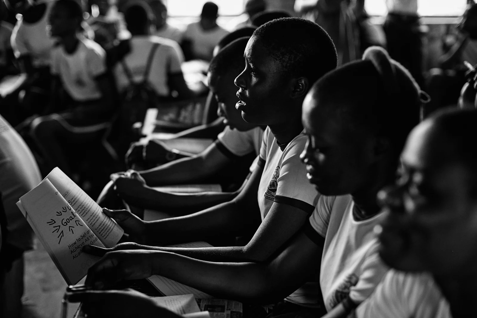 Young people reading together in a hall