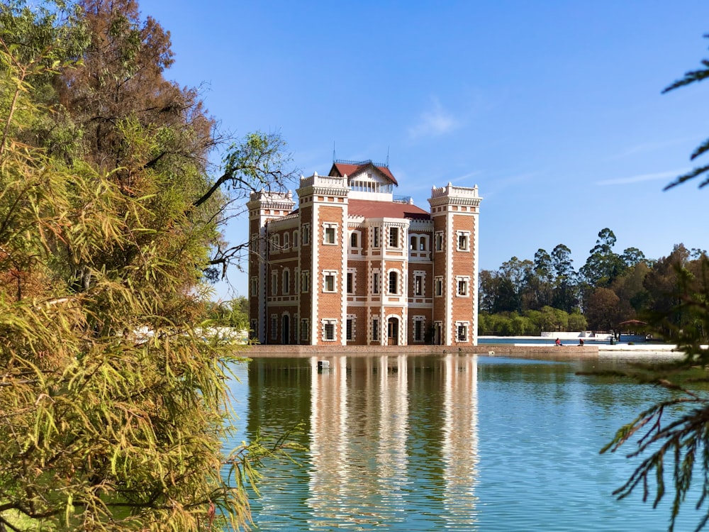 brown and white concrete building near body of water during daytime