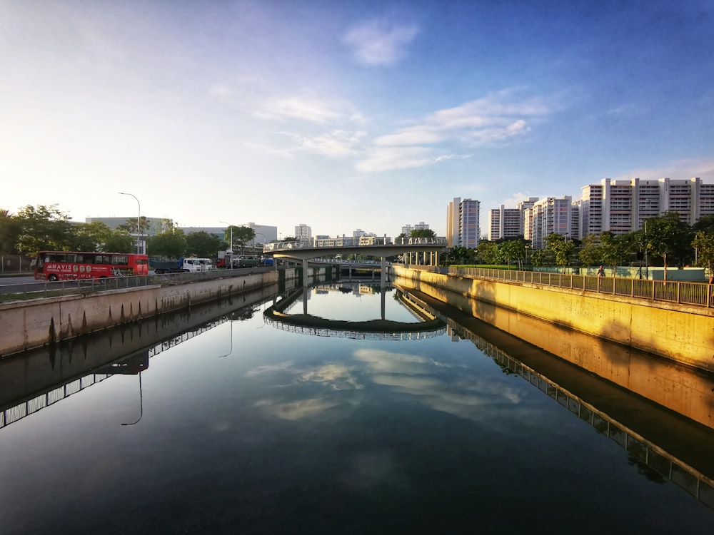 body of water near city buildings during daytime