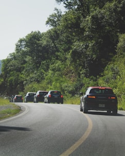 A group of people enjoying a recreational outing in electric vehicles on a scenic route.