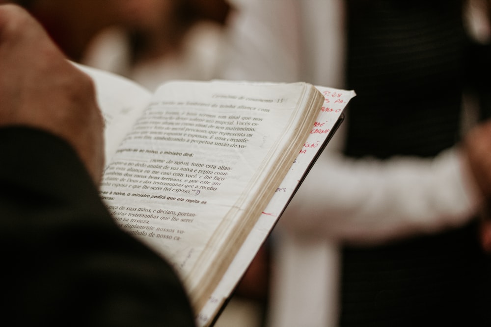 person reading book in tilt shift lens