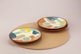2 round brown wooden plates