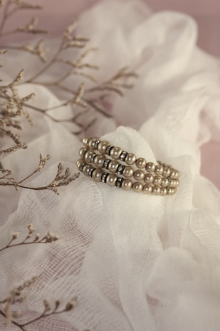 gold ring on white and brown floral textile