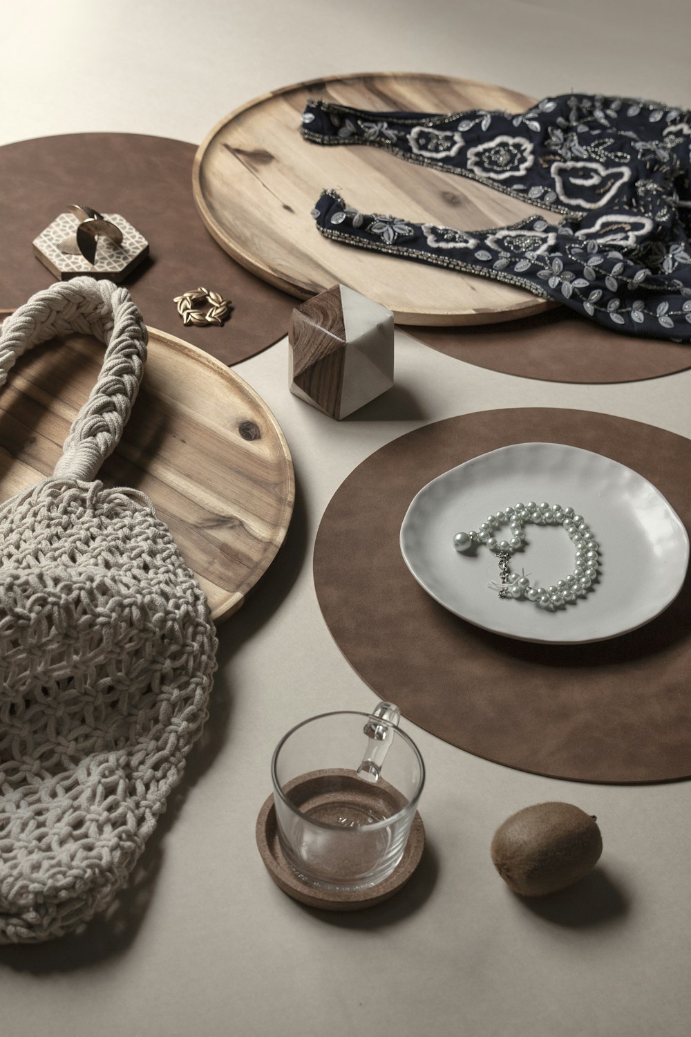 white and blue floral ceramic round plate beside clear drinking glass on brown wooden table