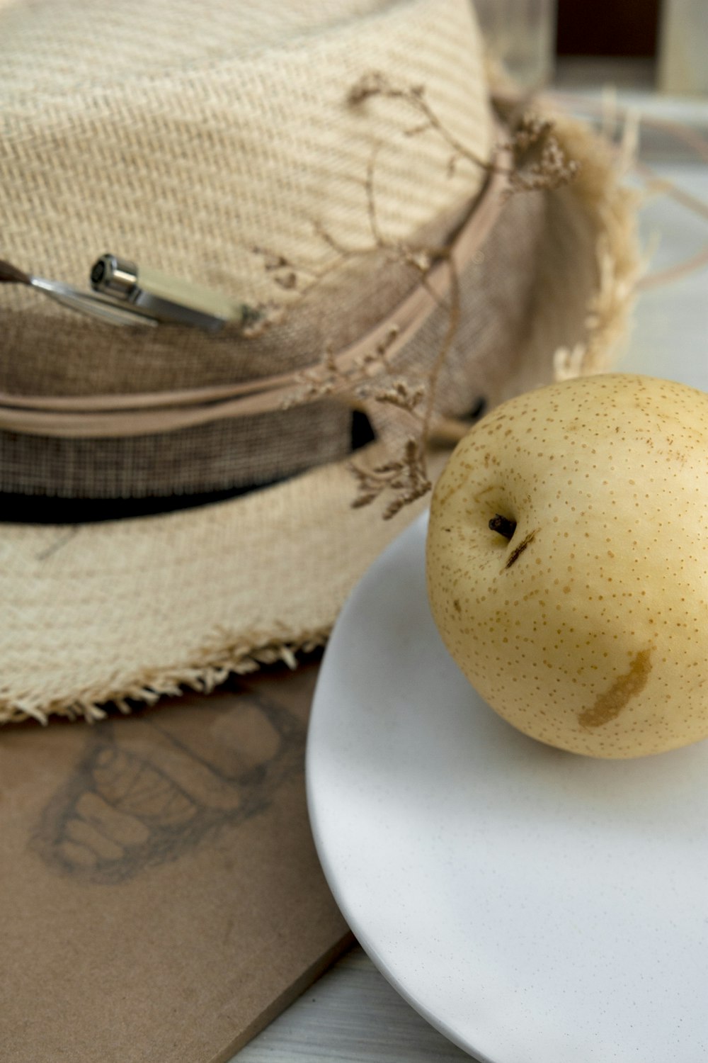 brown round fruit on white ceramic plate